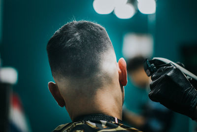 Rear view portrait of man showing hair cut