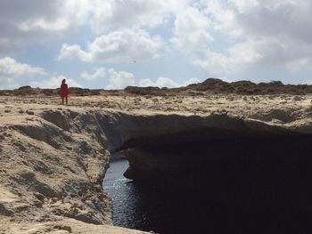 Tourists standing on rock formation