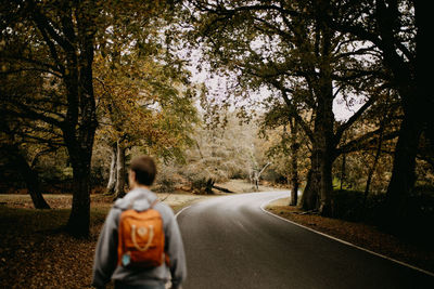 Rear view of woman walking on road