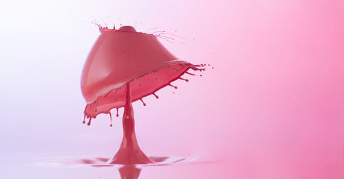 Close-up of splash crown against colored background