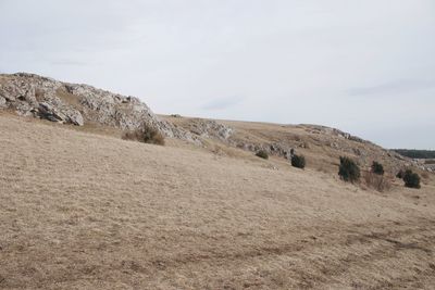 Scenic view of hill against sky