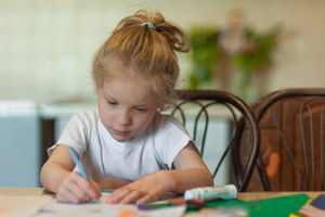 Portrait of girl sitting on table