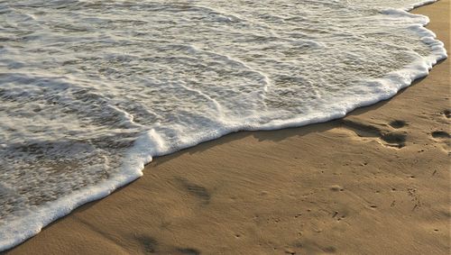 High angle view of footprints on sand at beach