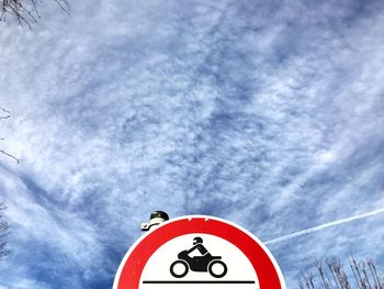 Low angle view of sign against sky