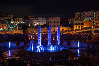 Illuminated city buildings at waterfront