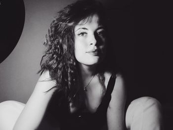 Close-up portrait of young woman at home
