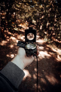 Close-up of hand holding navigational compass