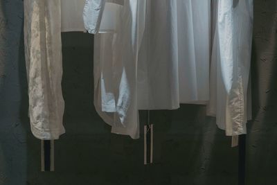 Close-up of clothes drying against wall at home