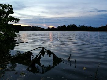 Scenic view of lake against sky at sunset