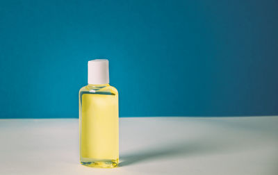 Close-up of bottle against blue background