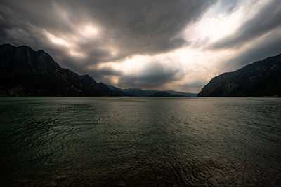 Scenic view of sea and mountains against sky