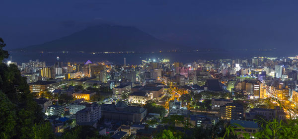 High angle view of city lit up at night