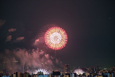 Cityscape illuminated by fireworks at night