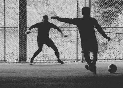 Friends playing soccer at park