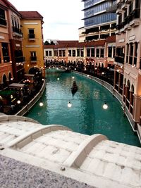 View of swimming pool in canal against buildings