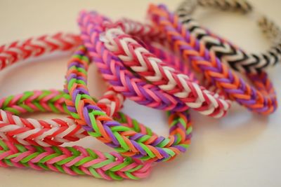 Multi colored bracelets on white table