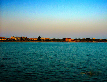 Scenic view of sea against clear sky at sunset