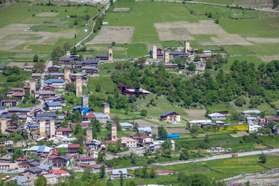 High angle view of houses and trees on field