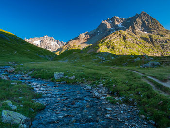 Scenic view of mountains against clear blue sky