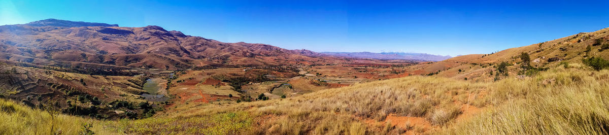 Scenic view of mountains against clear blue sky