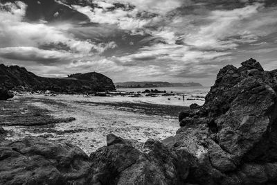 Rocks on beach against sky