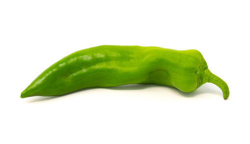 Close-up of green chili pepper against white background