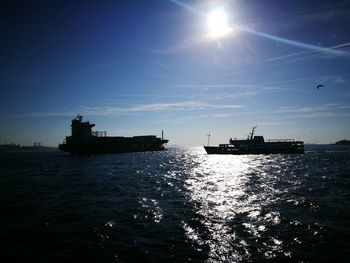 Silhouette ship sailing on sea against sky during sunset