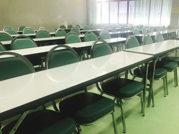 Empty chairs and table in classroom