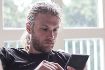 Man using mobile phone at home