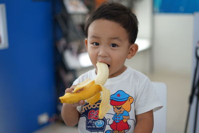 Close-up of cute boy eating banana