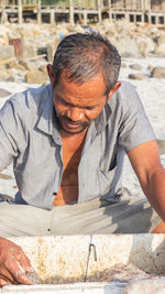 A fisherman is filtering his caught shrimp, traditional fisherman, fisherman who catches shrimp