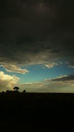 Silhouette of landscape against cloudy sky