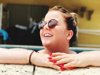 Close-up of young woman wearing sunglasses in swimming pool