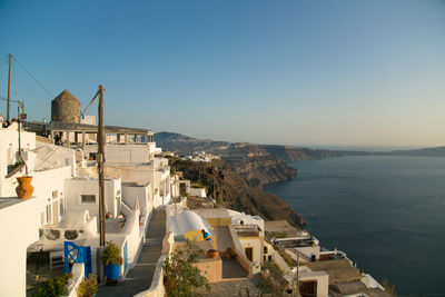 High angle view of town by sea against clear sky