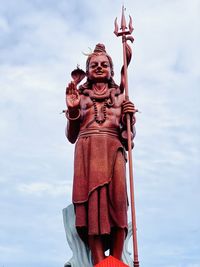 Low angle view of statue against sky