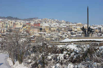 View of cityscape against clear sky during winter