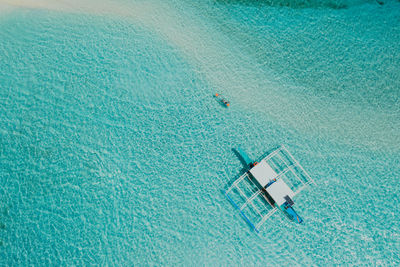 Drone view of man kayaking in sea on sunny day