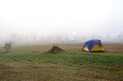 Tent on field against sky