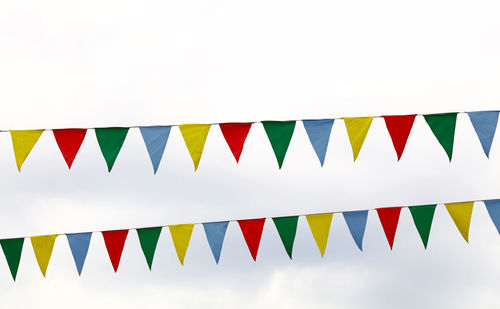 Low angle view of flags against sky