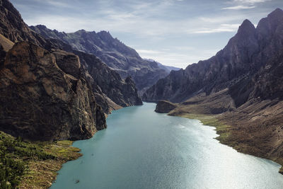 Scenic view of river amidst mountains against sky