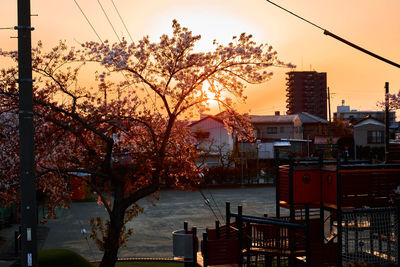Canal amidst buildings against sky during sunset