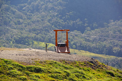 Lifeguard hut on field against mountain