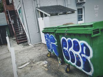 Garbage bin against blue wall