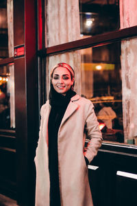 Portrait of young woman standing in store