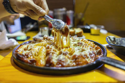 Close-up of person preparing food on table