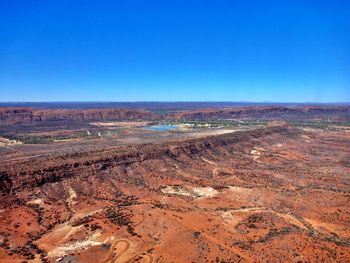 Scenic view of desert against clear blue sky