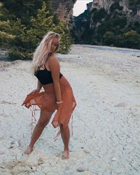 Portrait of beautiful young woman posing at beach 