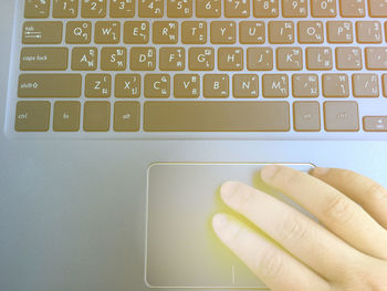 Hand using laptop