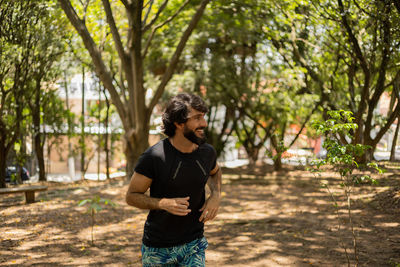 Man running and jogging at a park outdoors. male person workout. feel good, healthy concept. 