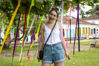 Portrait of smiling young woman standing outdoors